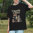 Women's Unearth A Story Dinosaur Reading a Library Book Graphic Youth Women's Unearth A Story Dinosaur Reading a Library Book Graphic Youth