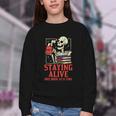 Staying Alive One Book At A Time Skeleton Reading Librarian Youth Crewneck Sweatshirt Staying Alive One Book At A Time Skeleton Reading Librarian Youth Crewneck Sweatshirt