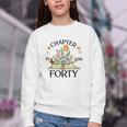 1986 Chapter Forty 40th Birthday Wildflower Book Youth Crewneck Sweatshirt 1986 Chapter Forty 40th Birthday Wildflower Book Youth Crewneck Sweatshirt