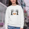 Skeleton Reading Book In Hammock Halloween Reader Youth Crewneck Sweatshirt