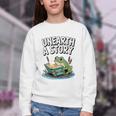 Unearth a Story Frog Reading a Book Summer 2026 Premium Tri-Blend Youth Crewneck Sweatshirt Unearth a Story Frog Reading a Book Summer 2026 Premium Tri-Blend Youth Crewneck Sweatshirt