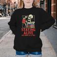 Staying Alive One Book At A Time Skeleton Reading Librarian Youth Crewneck Sweatshirt Staying Alive One Book At A Time Skeleton Reading Librarian Youth Crewneck Sweatshirt