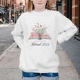 Quote New Chapter Begins Retired 2025 Floral Open Book Youth Crewneck Sweatshirt Quote New Chapter Begins Retired 2025 Floral Open Book Youth Crewneck Sweatshirt