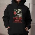Staying Alive One Book At A Time Skeleton Reading Librarian Graphic Youth Hoodie
