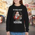 He Sees What You'Ve Been Reading Santa Book Lover Youth Long Sleeve Tee