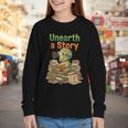 Unearth a Story Triceratops Dinosaur Reading Books Cute Dino Youth Long Sleeve Tee Unearth a Story Triceratops Dinosaur Reading Books Cute Dino Youth Long Sleeve Tee