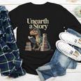 Women's Unearth A Story Dinosaur Reading a Library Book Youth Long Sleeve Tee Women's Unearth A Story Dinosaur Reading a Library Book Youth Long Sleeve Tee