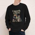 Unearth A Story Dinosaur Reading a Library Book Youth Long Sleeve Tee