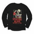 Staying Alive One Book At A Time Skeleton Reading Librarian Youth Long Sleeve Tee