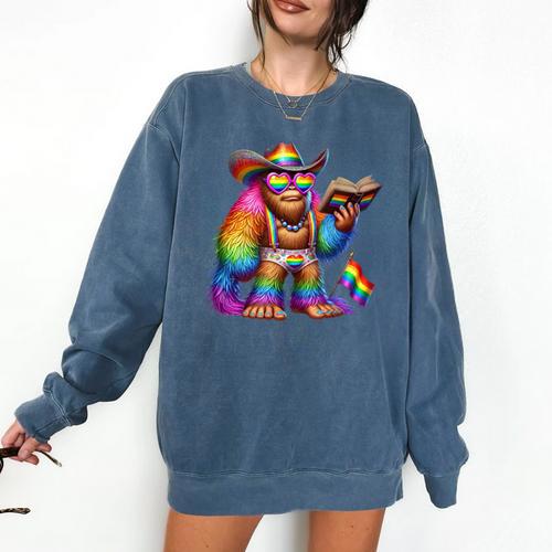 Rainbow Pride Bigfoot Reading Book With Heart Glasses Comfort Colors Sweatshirt - Bookorys