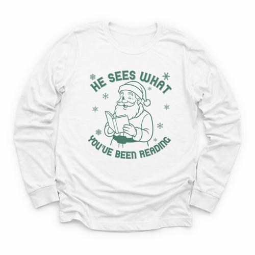 He Sees What You'Ve Been Reading Christmas Bookish Santa Premium Tri-Blend Youth Long Sleeve Tee - Bookorys AU