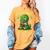 Book A Saurus Bookasaurus Dinosaur Book Girls Boys Toddler Women's Comfort Colors T-Shirt Mustard Book A Saurus Bookasaurus Dinosaur Book Girls Boys Toddler Women's Comfort Colors T-Shirt Mustard