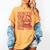 North Pole Book Club Christmas Women's Comfort Colors T-Shirt Mustard North Pole Book Club Christmas Women's Comfort Colors T-Shirt Mustard