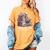 Reading A Book Per Day Keeps Reality Away Skeleton Books Women's Comfort Colors T-Shirt Mustard Reading A Book Per Day Keeps Reality Away Skeleton Books Women's Comfort Colors T-Shirt Mustard