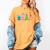 Reading Dinosaur T Rex Dino Book Lover Women's Comfort Colors T-Shirt Mustard Reading Dinosaur T Rex Dino Book Lover Women's Comfort Colors T-Shirt Mustard
