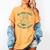 He Sees What You'Ve Been Reading Christmas Bookish Santa Premium Tri-Blend Women's Comfort Colors T-Shirt Mustard