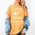 Woman Survives On Books Yarn Knitting Crochet Premium Tri-Blend Women's Comfort Colors T-Shirt Mustard