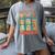 DCC Many Faces Of Mordecai Grid Gamer Series Book Women's Comfort Colors T-Shirt Gray DCC Many Faces Of Mordecai Grid Gamer Series Book Women's Comfort Colors T-Shirt Gray