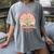 Unearth a Story 2026 Summer Reading Program Flowers Book Premium Tri-Blend Women's Comfort Colors T-Shirt Gray
