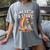 Unearth A Story Rainbow Treasure Book Women's Comfort Colors T-Shirt Gray Unearth A Story Rainbow Treasure Book Women's Comfort Colors T-Shirt Gray