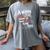 A Woman Cannot Survive On Books Alone She Also Needs Yarn Premium Women's Comfort Colors T-Shirt Gray