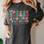 Groovy Christmas Most Likely To Read A Book On Christmas Women's Comfort Colors T-Shirt Pepper