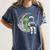 Astronaut Reading Book To Alien Moon Space Women Kids Men Premium Tri-Blend Women's Comfort Colors T-Shirt Moss