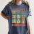 DCC Many Faces Of Mordecai Grid Gamer Series Book Women's Comfort Colors T-Shirt Moss DCC Many Faces Of Mordecai Grid Gamer Series Book Women's Comfort Colors T-Shirt Moss