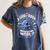 A Good Book Is Out Of This World Shirt Astronaut Reading Women's Comfort Colors T-Shirt Moss