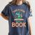 Take a Look It's In a Book Reading Teacher Book Lover Women's Comfort Colors T-Shirt Moss