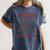Read Books Be Kind Stay Weird Bookish Cowboy Reading Raccoon Women's Comfort Colors T-Shirt Moss