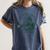 He Sees What You'Ve Been Reading Bookish Christmas Women's Comfort Colors T-Shirt Moss He Sees What You'Ve Been Reading Bookish Christmas Women's Comfort Colors T-Shirt Moss