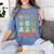 Women's DCC Many Faces Of Mordecai Grid Gamer Series Book Women's Comfort Colors T-Shirt Chalky Mint