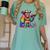 Rainbow Pride Bigfoot Reading Book With Heart Glasses Women's Comfort Colors T-Shirt Violet