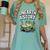 Unearth a Story Frog Reading a Book Summer 2026 Women's Comfort Colors T-Shirt Violet Unearth a Story Frog Reading a Book Summer 2026 Women's Comfort Colors T-Shirt Violet