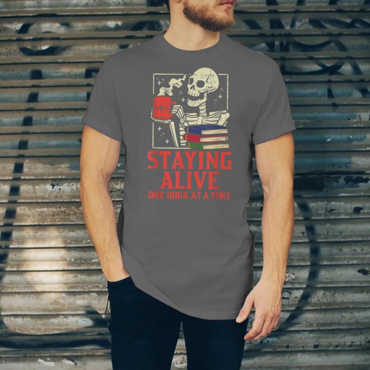 Staying Alive One Book At A Time Skeleton Reading Librarian Unisex Jersey T-Shirt