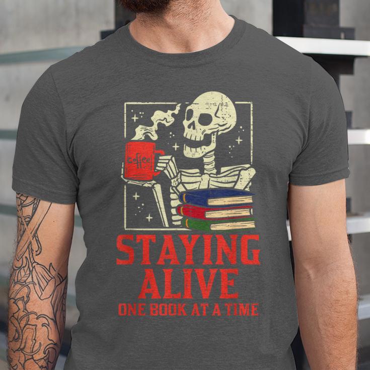 Staying Alive One Book At A Time Skeleton Reading Librarian Unisex Jersey T-Shirt