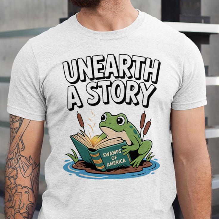 Unearth a Story Frog Reading a Book Summer 2026 Premium Tri-Blend Unisex Jersey T-Shirt Unearth a Story Frog Reading a Book Summer 2026 Premium Tri-Blend Unisex Jersey T-Shirt