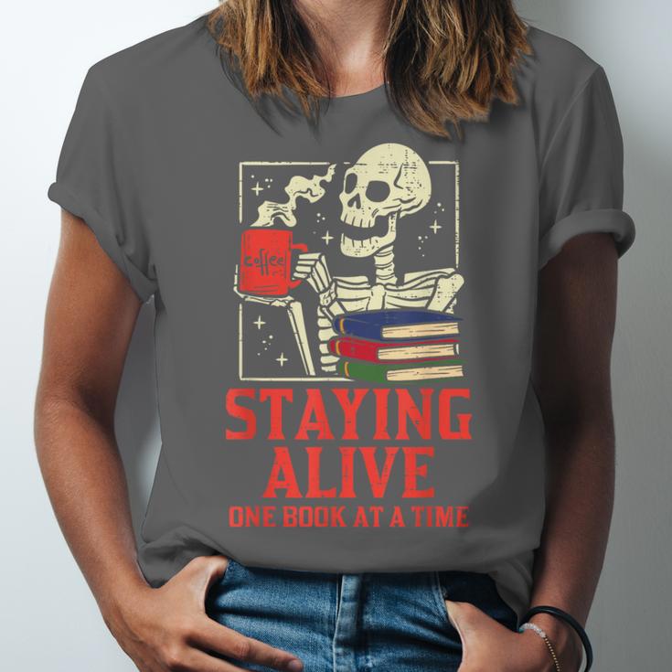 Staying Alive One Book At A Time Skeleton Reading Librarian Unisex Jersey T-Shirt