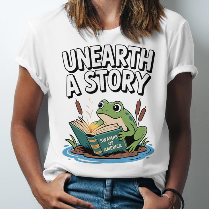 Unearth a Story Frog Reading a Book Summer 2026 Premium Tri-Blend Unisex Jersey T-Shirt Unearth a Story Frog Reading a Book Summer 2026 Premium Tri-Blend Unisex Jersey T-Shirt
