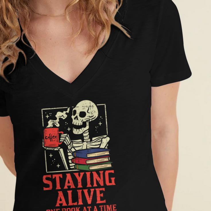 Staying Alive One Book At A Time Skeleton Reading Librarian Women's Jersey Short Sleeve Deep V-Neck Tshirt