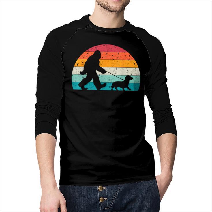 Retro Sasquatch Lover Doxie Wiener Dog Walker Bigfoot Walking a Dog Dachshund Weiner Dog Dad Weenie Small Men Baseball Raglan Shirt