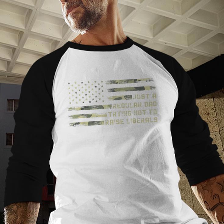 Just a Regular Dad Trying Not To Raise Liberals Camouflage Men Baseball Raglan Shirt