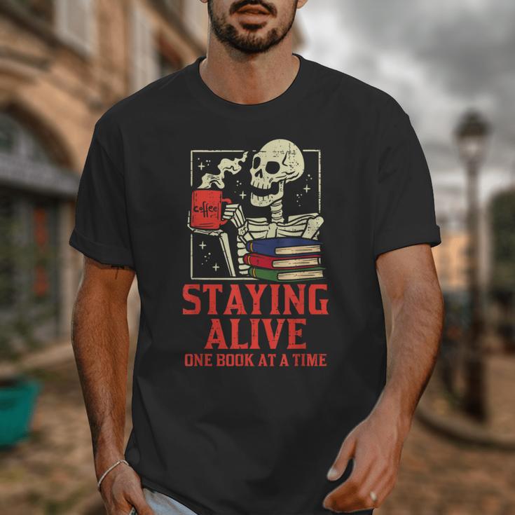 Staying Alive One Book At A Time Skeleton Reading Librarian Unisex T-Shirt Staying Alive One Book At A Time Skeleton Reading Librarian Unisex T-Shirt