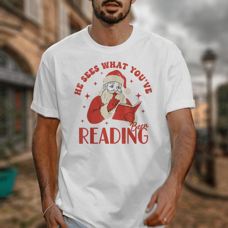 He Sees What You'Ve Been Reading Santa Book Unisex T-Shirt He Sees What You'Ve Been Reading Santa Book Unisex T-Shirt