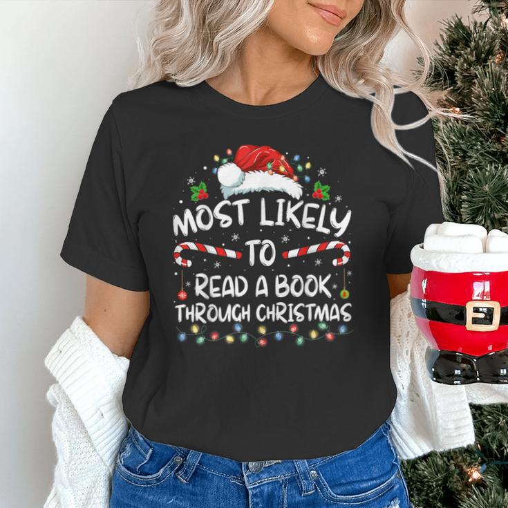 Most Likely To Read A Book Through Christmas Xmas Unisex T-Shirt Most Likely To Read A Book Through Christmas Xmas Unisex T-Shirt