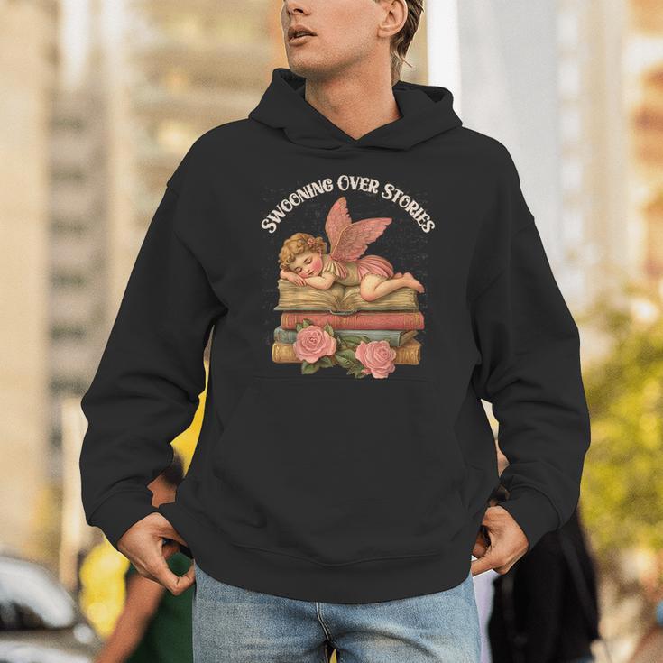 Valentine's Swooning Over Stories Cupid And Book Lover Tee Unisex Hoodie Valentine's Swooning Over Stories Cupid And Book Lover Tee Unisex Hoodie