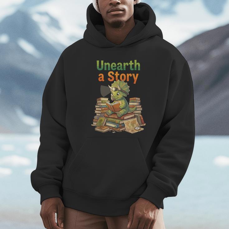 Unearth a Story Triceratops Dinosaur Reading Books Cute Dino Unisex Hoodie Unearth a Story Triceratops Dinosaur Reading Books Cute Dino Unisex Hoodie