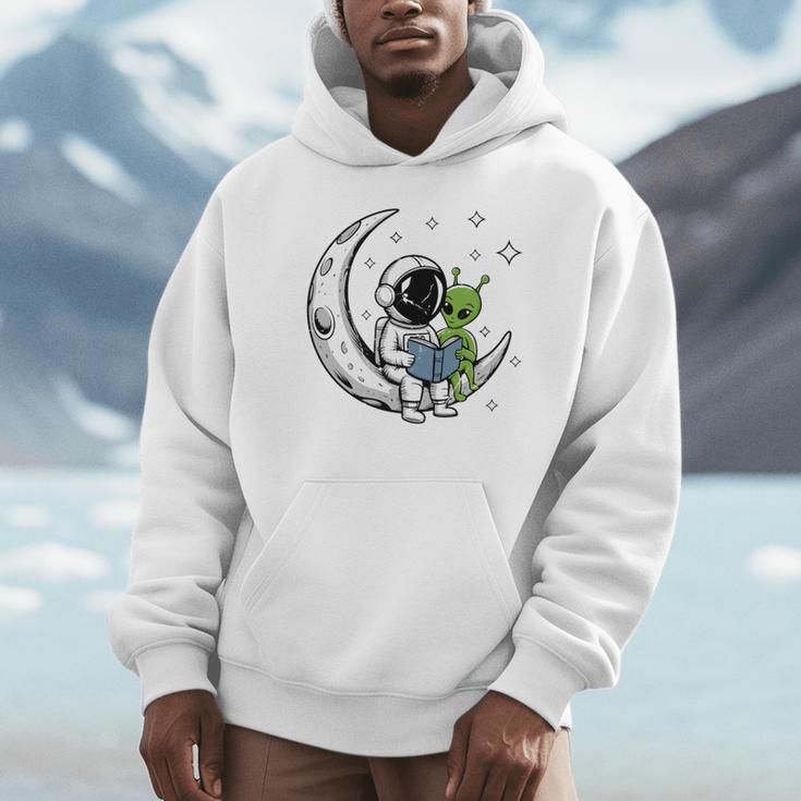 Astronaut Reading Book To Alien Moon Space Astronomy Unisex Hoodie