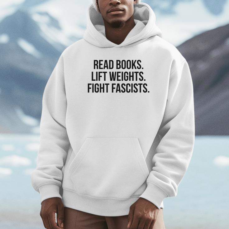 Read Books Lift Weights Fight Fascists Premium Tri-Blend Unisex Hoodie